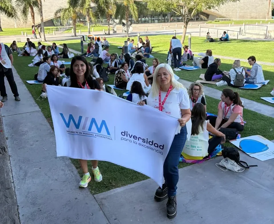 Grupo de mujeres de la industria minera posan con un cartel de WIM Argentina en San Juan.