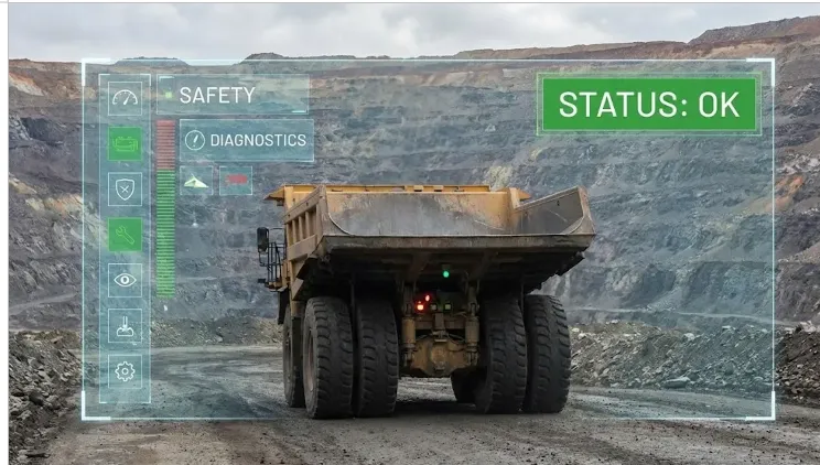 Camión minero de alto tonelaje en operación con un display de monitoreo de seguridad y riesgos en la cabina.
