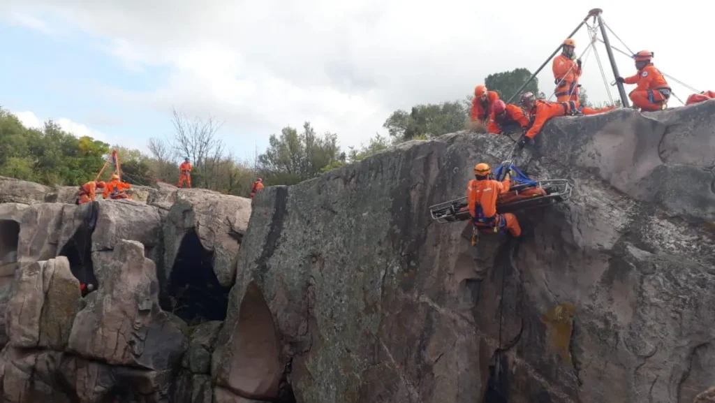 brigadistas ejecutando rescate vertical con camilla en práctica de alta complejidad