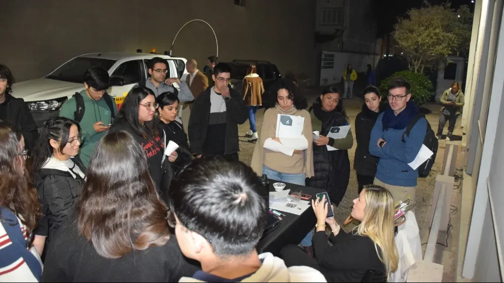 Especialista en recursos humanos revisa currículums de estudiantes e ingenieros jóvenes durante una jornada profesional.