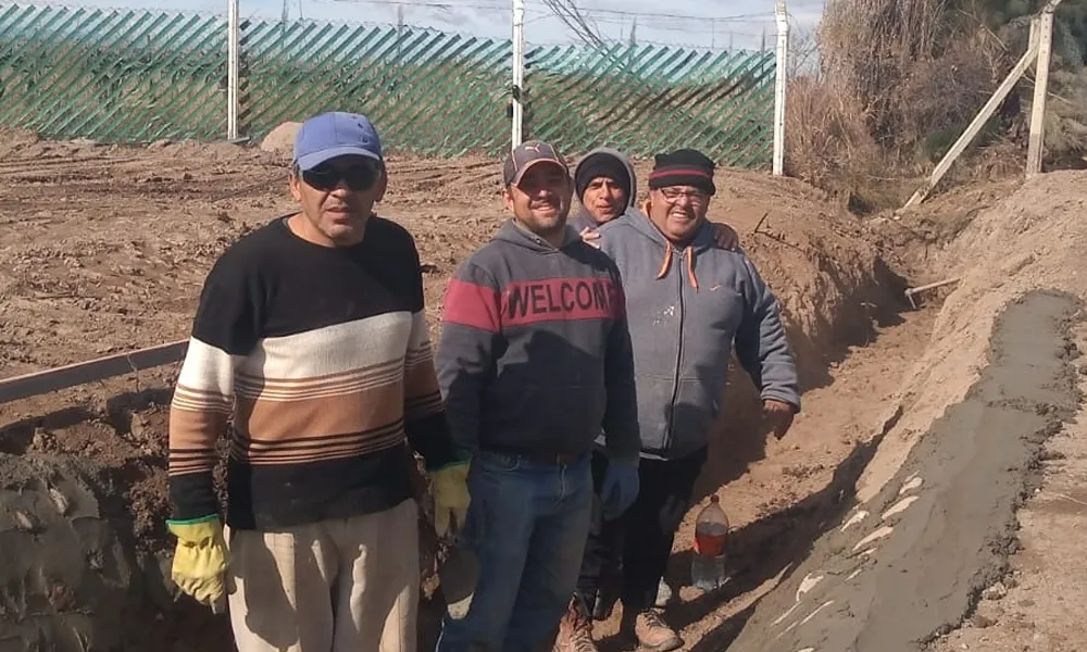 Miembros de la Agrupación Cordillera de los Andes trabajando.  hoombre en una zanja