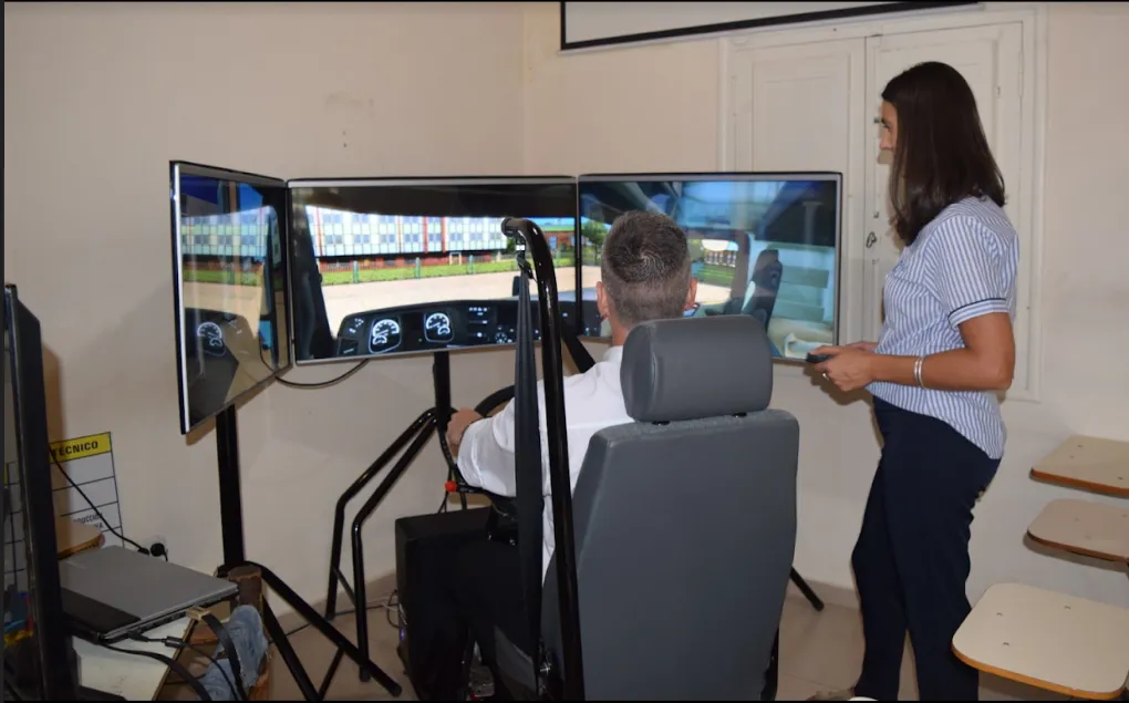 Alumno con una docente tomando clases en un simulador de manejo