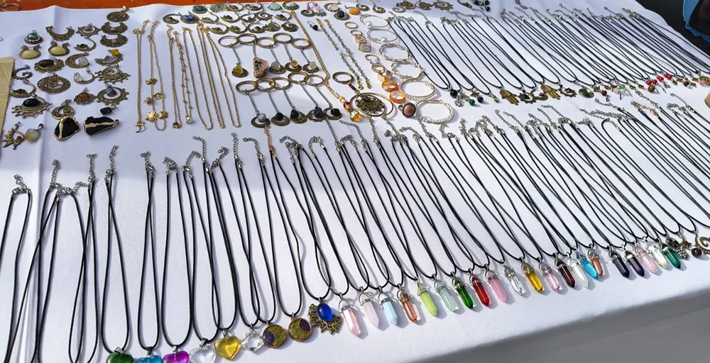 Exhibición de collares, dijes, pulseras y piezas de bijouterie artesanal elaboradas con piedras, minerales, alambre y distintos engarces por el artesano Sergio Mayorga.