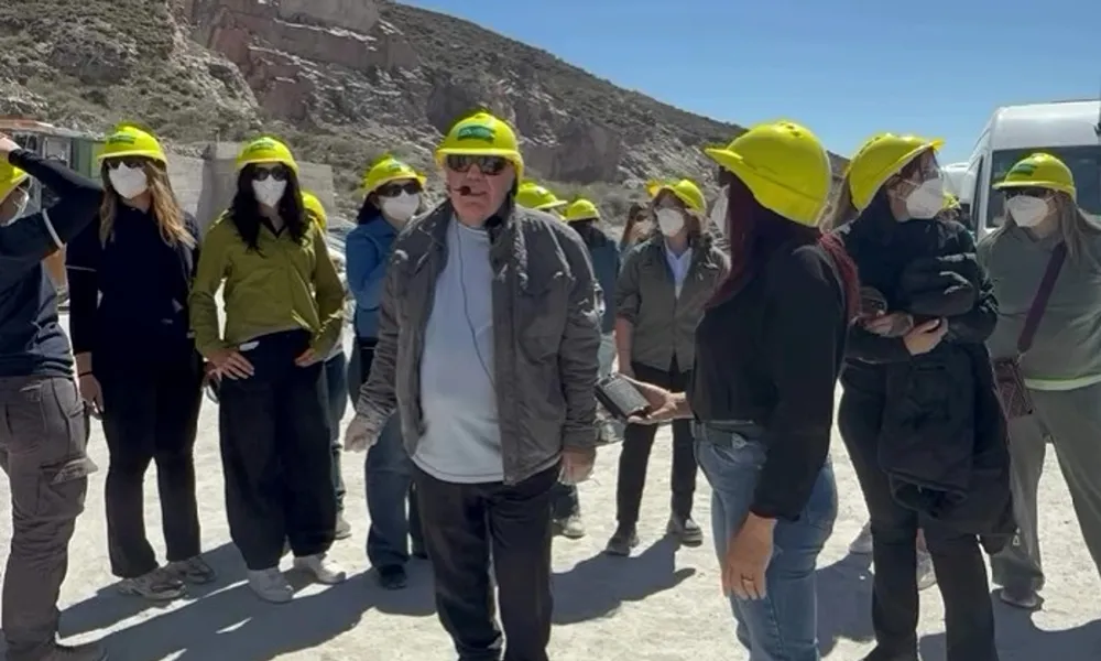 Padre de Analía Pérez explica el funcionamiento de Más Minerales durante una recorrida por la planta junto a visitantes en Sarmiento.